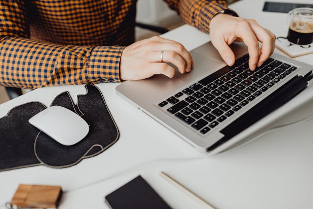 Zoomed-in image of someone working on a Macbook.